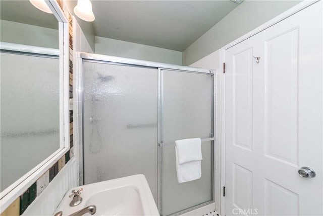 bathroom with sink and an enclosed shower