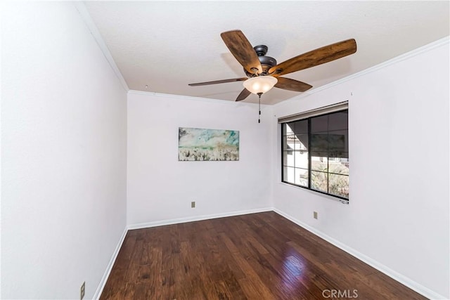 empty room featuring dark wood-type flooring, ornamental molding, and ceiling fan