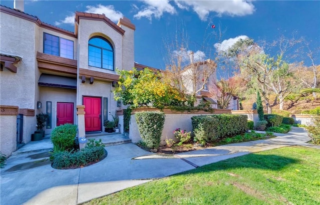 view of exterior entry with a yard