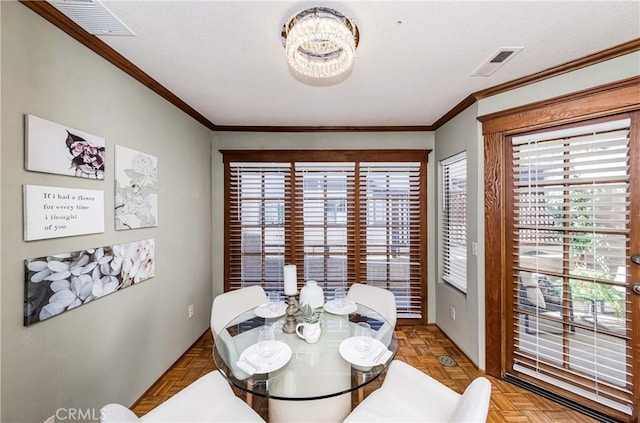 dining space featuring crown molding and light parquet flooring