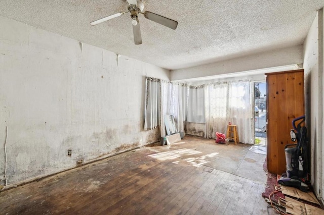 unfurnished room with a textured ceiling, ceiling fan, and light wood-type flooring