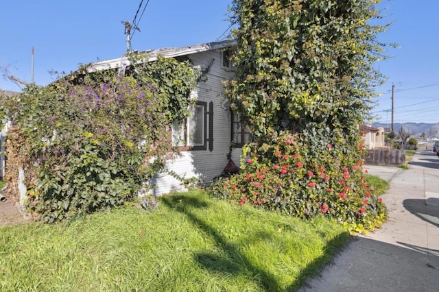 view of side of home featuring a lawn