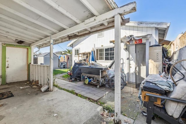 view of patio with a storage shed