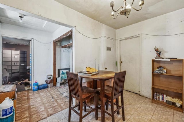 dining area with an inviting chandelier