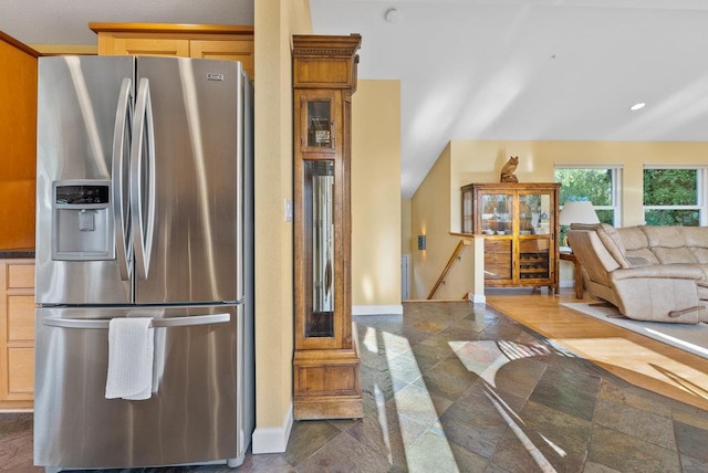 kitchen featuring stainless steel fridge and light brown cabinets