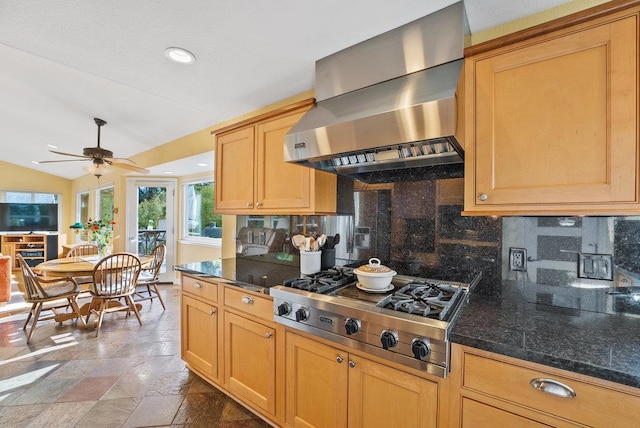 kitchen with vaulted ceiling, stainless steel gas stovetop, backsplash, exhaust hood, and ceiling fan