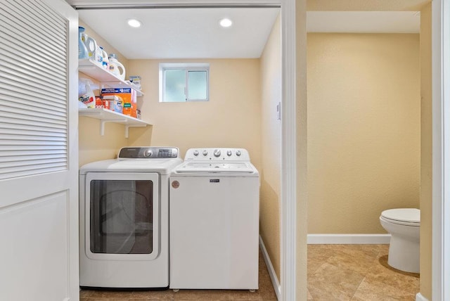 clothes washing area featuring washer and dryer