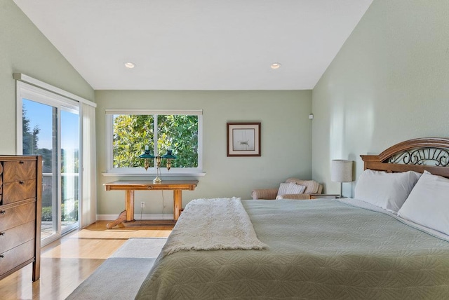 bedroom with vaulted ceiling, light hardwood / wood-style flooring, and access to outside