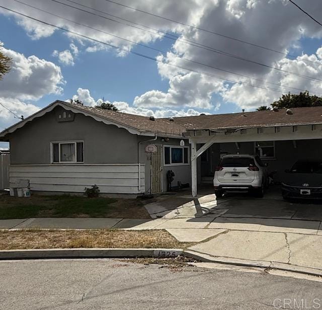 ranch-style home featuring a carport