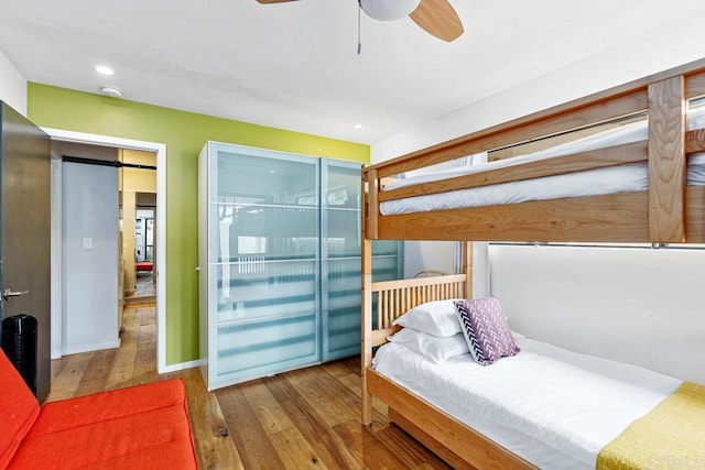 bedroom featuring hardwood / wood-style floors and ceiling fan