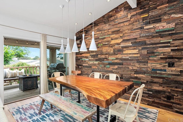 dining area featuring wood-type flooring and lofted ceiling