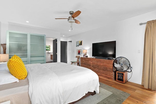 bedroom with ceiling fan and light hardwood / wood-style flooring