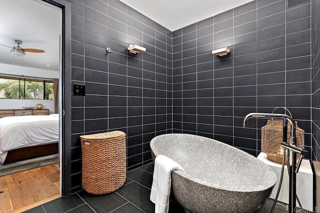 bathroom with tile patterned flooring, tile walls, and ceiling fan