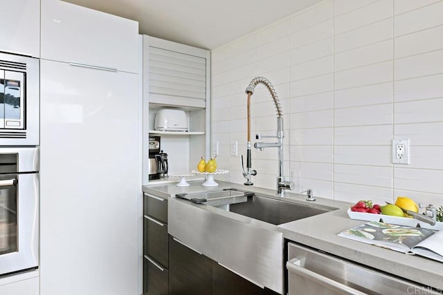 kitchen featuring sink, white cabinets, and appliances with stainless steel finishes