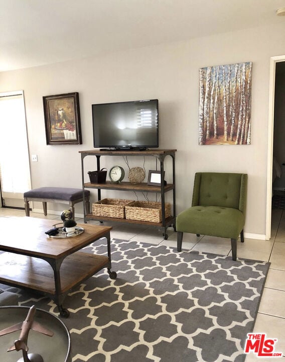 living area featuring tile patterned floors