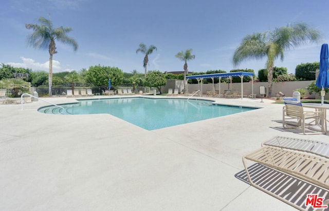 view of swimming pool with a patio