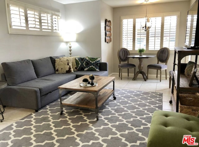 tiled living room with a notable chandelier