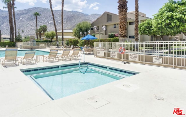 view of pool featuring a patio and a mountain view