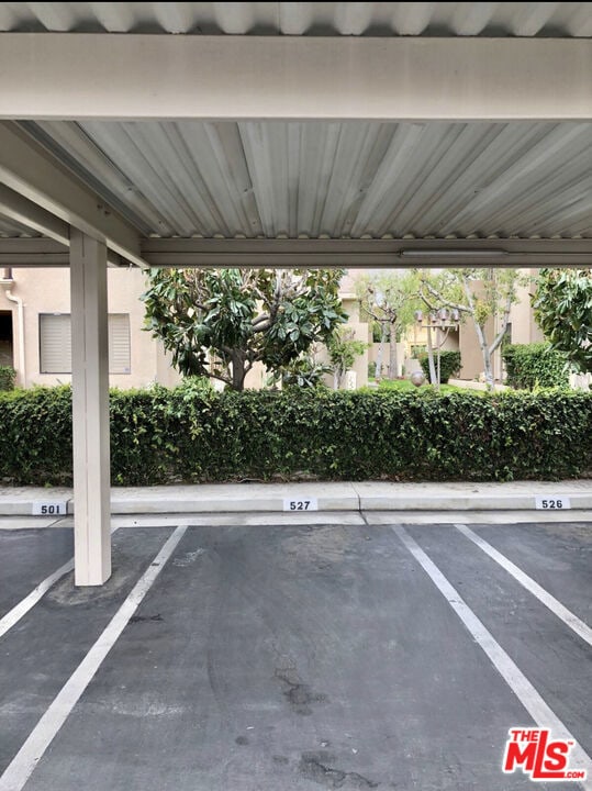 view of vehicle parking with a carport