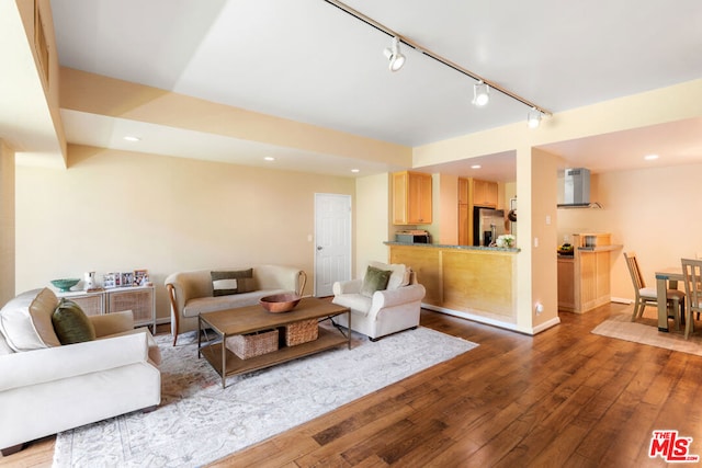 living room featuring track lighting and wood-type flooring