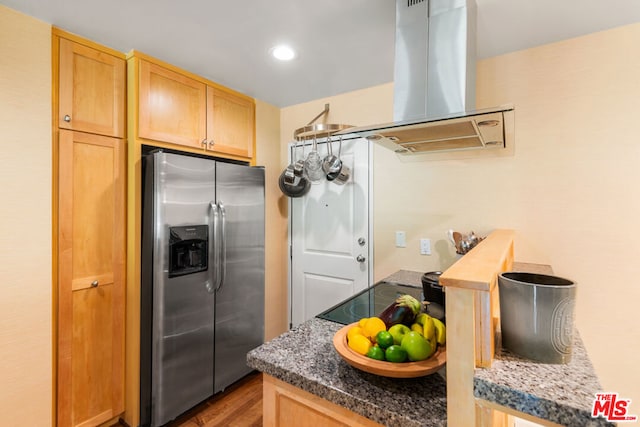 kitchen featuring black electric stovetop, wood-type flooring, island exhaust hood, light brown cabinetry, and stainless steel fridge with ice dispenser