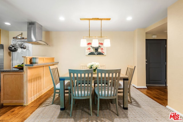 dining area with hardwood / wood-style flooring