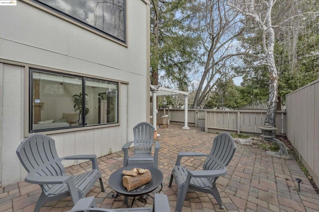 view of patio / terrace with an outdoor fire pit and a pergola