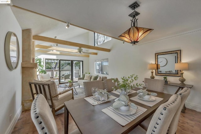 dining area featuring hardwood / wood-style flooring, lofted ceiling, and ceiling fan