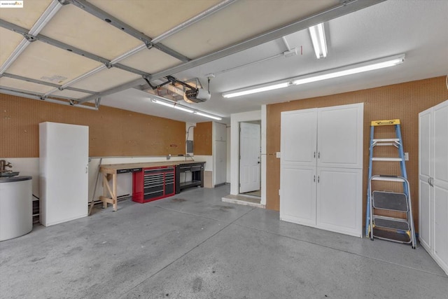 garage featuring a garage door opener and a workshop area