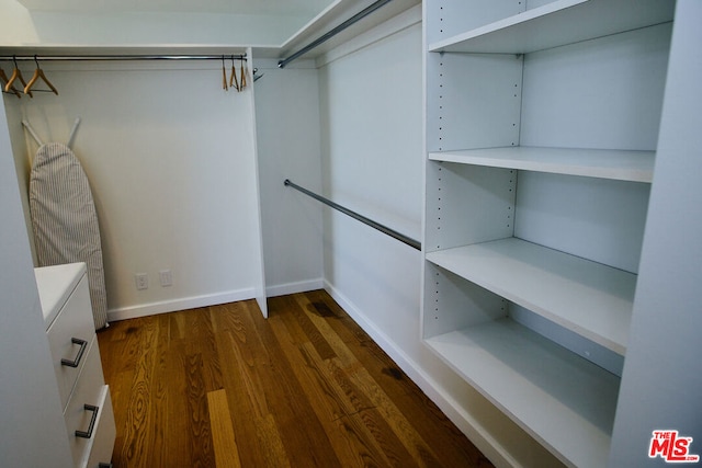 walk in closet featuring dark wood-type flooring