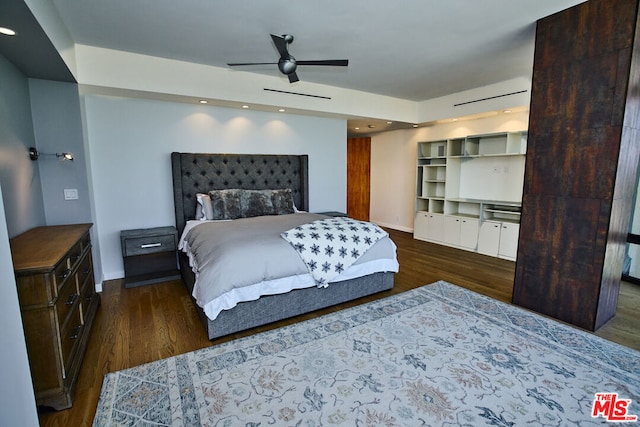 bedroom with ceiling fan and dark hardwood / wood-style floors