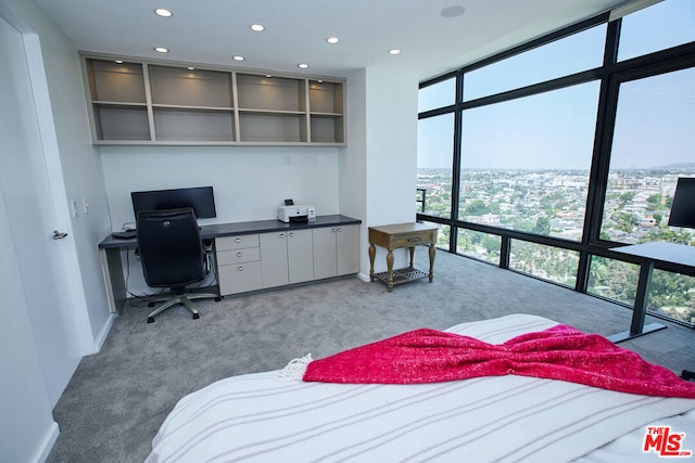 bedroom with expansive windows and carpet floors