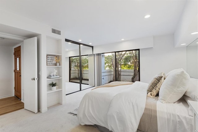 bedroom with light colored carpet and access to outside