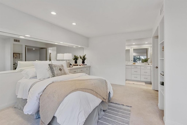 carpeted bedroom featuring connected bathroom