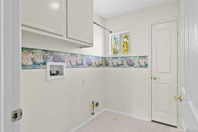 laundry room with washer hookup, hookup for a gas dryer, and cabinets