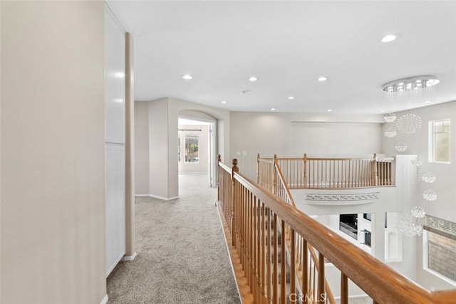 hallway featuring light colored carpet