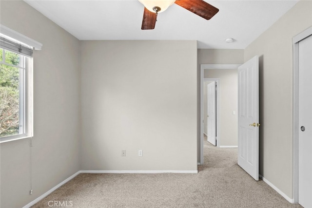 unfurnished bedroom with light carpet, multiple windows, and baseboards