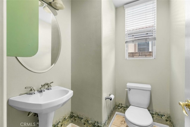 bathroom featuring sink, tile patterned floors, and toilet