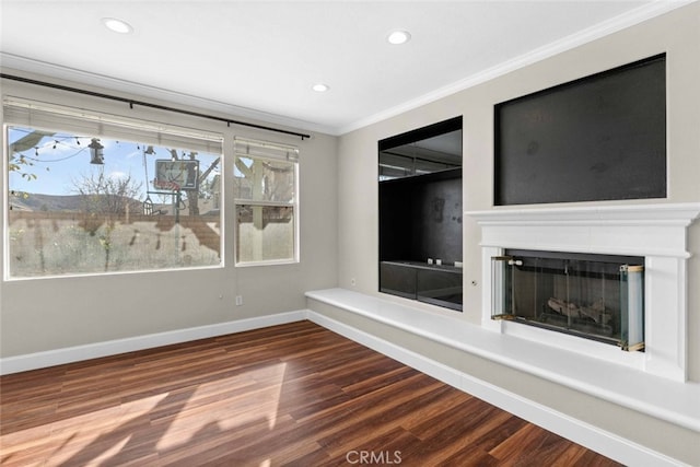 interior space with baseboards, a fireplace with raised hearth, crown molding, and wood finished floors