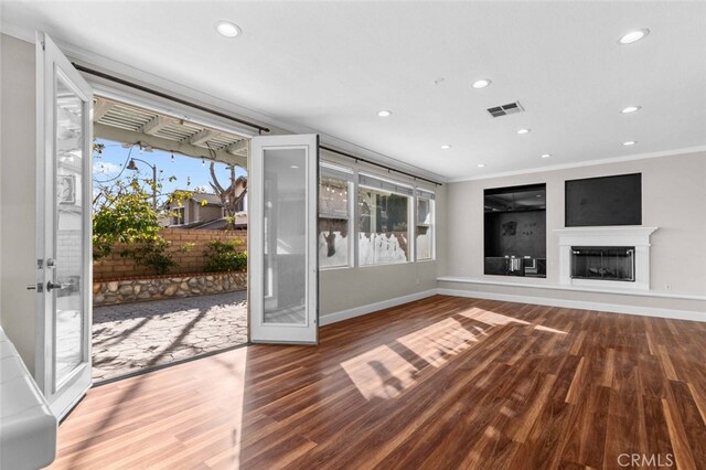 interior space featuring ornamental molding, wood-type flooring, and a wealth of natural light