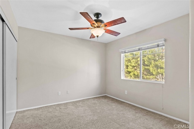 carpeted empty room featuring ceiling fan