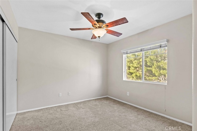 unfurnished bedroom with carpet floors, a closet, baseboards, and a ceiling fan