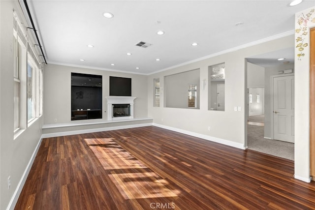 unfurnished living room with visible vents, ornamental molding, a fireplace with raised hearth, and baseboards