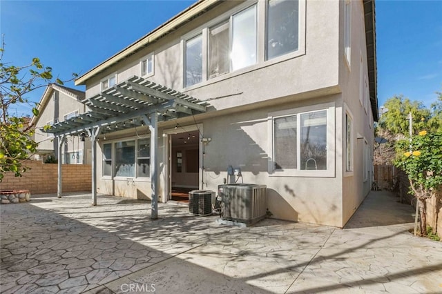 view of front of house featuring a patio, central air condition unit, and a pergola