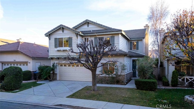 craftsman-style house featuring concrete driveway, stone siding, a chimney, an attached garage, and a front yard