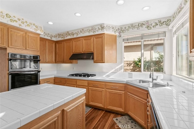 kitchen with sink, tile countertops, dark hardwood / wood-style flooring, and double oven