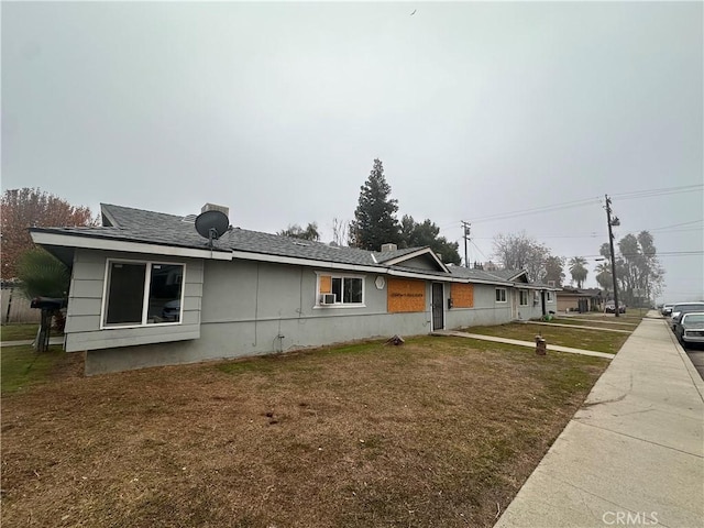 view of side of property with a lawn