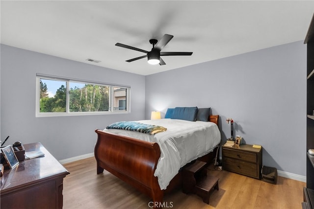 bedroom with light hardwood / wood-style flooring and ceiling fan