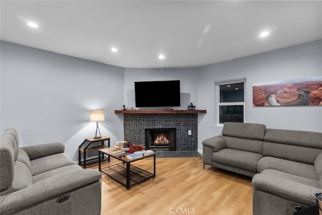 living room with hardwood / wood-style floors and a fireplace