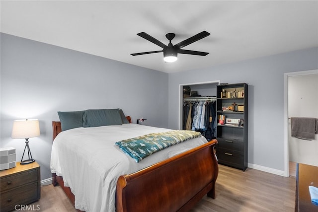 bedroom featuring hardwood / wood-style floors, a closet, and ceiling fan